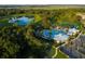 Stunning aerial view of the community showcasing the pool, clubhouse, and surrounding green spaces at 1590 Contentment Loop, Kissimmee, FL 34744
