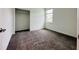 Bright bedroom with neutral carpet, a large window and a walk-in closet provides storage at 1590 Contentment Loop, Kissimmee, FL 34744