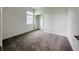 Bright bedroom with neutral carpet, a large window and a walk-in closet provides storage at 1590 Contentment Loop, Kissimmee, FL 34744