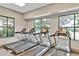 Fitness center equipped with modern treadmills overlooking the community pool at 1590 Contentment Loop, Kissimmee, FL 34744