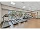 Bright fitness center with an array of cardio equipment and ample natural light at 1590 Contentment Loop, Kissimmee, FL 34744