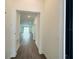 Inviting hallway with wood-style flooring, leading to the home's bright and open living spaces at 1590 Contentment Loop, Kissimmee, FL 34744