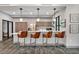 Modern kitchen featuring stainless steel appliances, sleek countertops, and stylish barstool seating at 1590 Contentment Loop, Kissimmee, FL 34744
