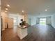 Open-concept kitchen with stainless steel appliances and a center island with a breakfast bar at 1590 Contentment Loop, Kissimmee, FL 34744