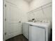Functional laundry room featuring a washer, dryer, and storage shelf at 1590 Contentment Loop, Kissimmee, FL 34744