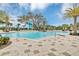 Large community pool surrounded by lush landscaping and comfortable seating at 1590 Contentment Loop, Kissimmee, FL 34744