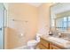 Cozy bathroom featuring a granite vanity top, toilet, and walk-in shower at 1621 Sunny St, Kissimmee, FL 34741