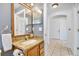 Well-lit bathroom featuring granite countertops, a vanity with mirrors, and modern fixtures at 1621 Sunny St, Kissimmee, FL 34741