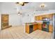 Open concept showcasing kitchen with granite countertops, stainless steel appliances, and a breakfast bar at 1621 Sunny St, Kissimmee, FL 34741