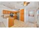 Bright kitchen featuring wooden cabinets, stainless steel appliances, granite countertops, and access to the back door at 1621 Sunny St, Kissimmee, FL 34741