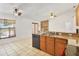 Bright kitchen featuring granite countertops, tiled flooring, and modern appliances with eat-in dining area at 1621 Sunny St, Kissimmee, FL 34741