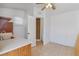 Eat-in kitchenette featuring tiled floors and a stainless steel sink with a view to an open shower at 1621 Sunny St, Kissimmee, FL 34741