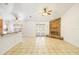 Open living space with tile flooring, a stone fireplace, and a view of the kitchen with bar seating at 1621 Sunny St, Kissimmee, FL 34741