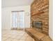 Living area highlighting a stone fireplace, tile flooring, and French doors leading to the outdoor space at 1621 Sunny St, Kissimmee, FL 34741