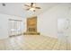 Open living room with tile flooring, a corner fireplace, and French doors leading to the exterior at 1621 Sunny St, Kissimmee, FL 34741