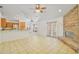 Spacious living area featuring a stone fireplace, tile floors, and easy access to the kitchen and patio at 1621 Sunny St, Kissimmee, FL 34741