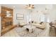 Bright living room featuring a beautiful stone fireplace, modern furnishings, and high ceilings with ceiling fans at 1621 Sunny St, Kissimmee, FL 34741