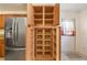 Spacious pantry with ample shelving for organized storage, adjacent to stainless steel refrigerator at 1621 Sunny St, Kissimmee, FL 34741