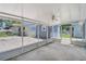 Screened patio with concrete flooring and white metal framing offering an outdoor view of backyard at 1621 Sunny St, Kissimmee, FL 34741
