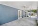 Covered patio featuring concrete flooring, a ceiling fan, and screened in enclosure with outdoor view at 1621 Sunny St, Kissimmee, FL 34741