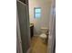 Compact bathroom featuring granite countertops, a vanity, and shower with glass door at 1695 E Horatio Ave, Maitland, FL 32751
