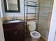 This bathroom has a tiled shower, toilet, vanity, and shelving at 1695 E Horatio Ave, Maitland, FL 32751