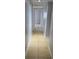 Hallway with tile floors and neutral paint leading to multiple rooms in the home at 1695 E Horatio Ave, Maitland, FL 32751