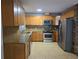 Bright kitchen features granite countertops, stainless appliances, and wood cabinetry at 1695 E Horatio Ave, Maitland, FL 32751