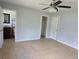 This main bedroom has tile floors, a ceiling fan, and an ensuite bathroom at 1695 E Horatio Ave, Maitland, FL 32751