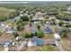 Aerial view of the neighborhood showing lush greenery and homes, with a pool visible at one of the properties at 1840 Lillian Dr, St Cloud, FL 34771