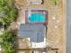 An aerial view of the home reveals its roof and a screened pool with red deck for outdoor relaxation at 1840 Lillian Dr, St Cloud, FL 34771