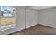 Bright bedroom features wood-look flooring, neutral paint, and a large window at 1840 Lillian Dr, St Cloud, FL 34771