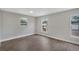 Bedroom features wood-look flooring, neutral paint, and multiple windows at 1840 Lillian Dr, St Cloud, FL 34771