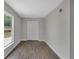 This bedroom features wood-look flooring, neutral paint, closet, and a large window at 1840 Lillian Dr, St Cloud, FL 34771