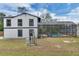 View of the two-story house and the screened in pool in the backyard at 1840 Lillian Dr, St Cloud, FL 34771