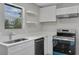 Bright kitchen featuring white cabinets, stainless steel appliances, and quartz countertops at 1840 Lillian Dr, St Cloud, FL 34771
