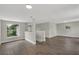 Open concept living area with wood-look floors, neutral paint and stairway at 1840 Lillian Dr, St Cloud, FL 34771