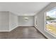 Living room with wood-look floors, neutral paint, and bright natural light at 1840 Lillian Dr, St Cloud, FL 34771