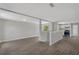 Open concept living area with wood-look floors, neutral paint, and bright kitchen view at 1840 Lillian Dr, St Cloud, FL 34771