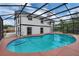 A screened-in pool is located next to a white two-story house providing a refreshing escape on warm days at 1840 Lillian Dr, St Cloud, FL 34771