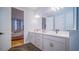 Bright bathroom featuring a double vanity with white countertops and tile flooring at 18851 Rawson St, Orlando, FL 32827