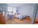 Cozy bedroom featuring wood floors, a metal bed frame and natural light from a window at 18851 Rawson St, Orlando, FL 32827
