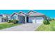 A well-maintained single Gathering home features a brick driveway and inviting landscaping at 18851 Rawson St, Orlando, FL 32827