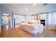Spacious kitchen with a large island, white cabinetry and hardwood flooring at 18851 Rawson St, Orlando, FL 32827
