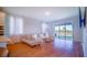 Living room with neutral tones and hardwood floors leads out to the backyard at 18851 Rawson St, Orlando, FL 32827