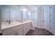 A main bathroom with a double vanity, quartz countertops, and glass shower at 18851 Rawson St, Orlando, FL 32827