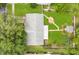 Aerial view of a well-maintained property with a lush backyard, patio, firepit, and shed at 2095 Curry Ln, Orlando, FL 32812