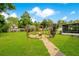 Picturesque backyard featuring a garden arbor, cozy fire pit, and well-maintained lawn area at 2095 Curry Ln, Orlando, FL 32812
