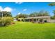 Lush backyard with a covered patio, garden arbor, and green lawn provides ample space at 2095 Curry Ln, Orlando, FL 32812