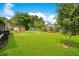 Lush backyard featuring well-manicured lawn and a quaint shed surrounded by trees at 2095 Curry Ln, Orlando, FL 32812